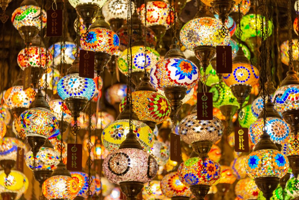 Colorful Turkish lanterns hang in a mesmerizing indoor display, creating a vibrant, cultural atmosphere.