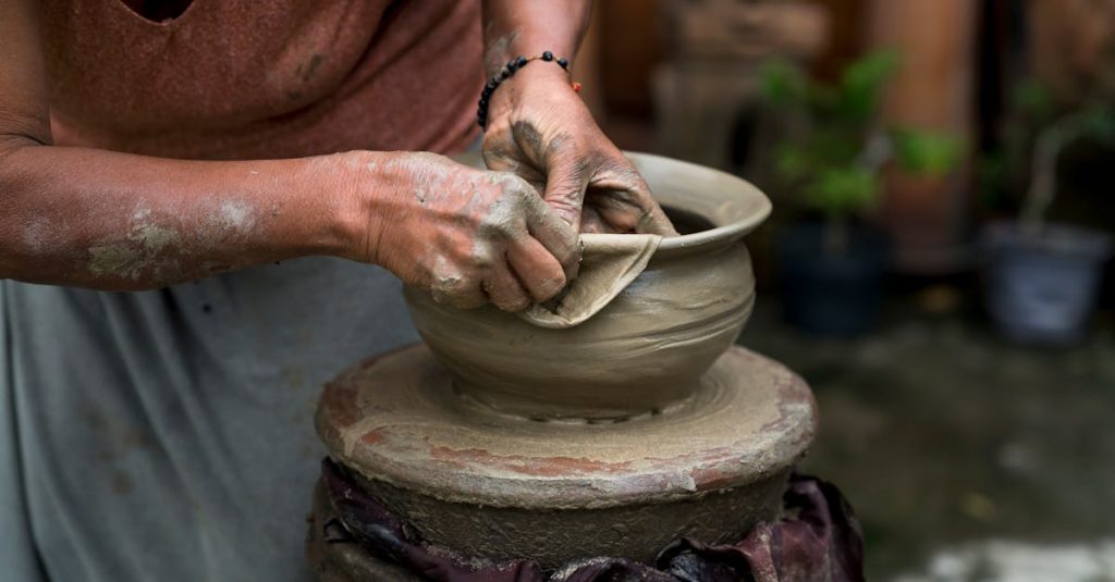 A skilled potter shaping clay on a wheel, showcasing traditional craftsmanship and creativity.