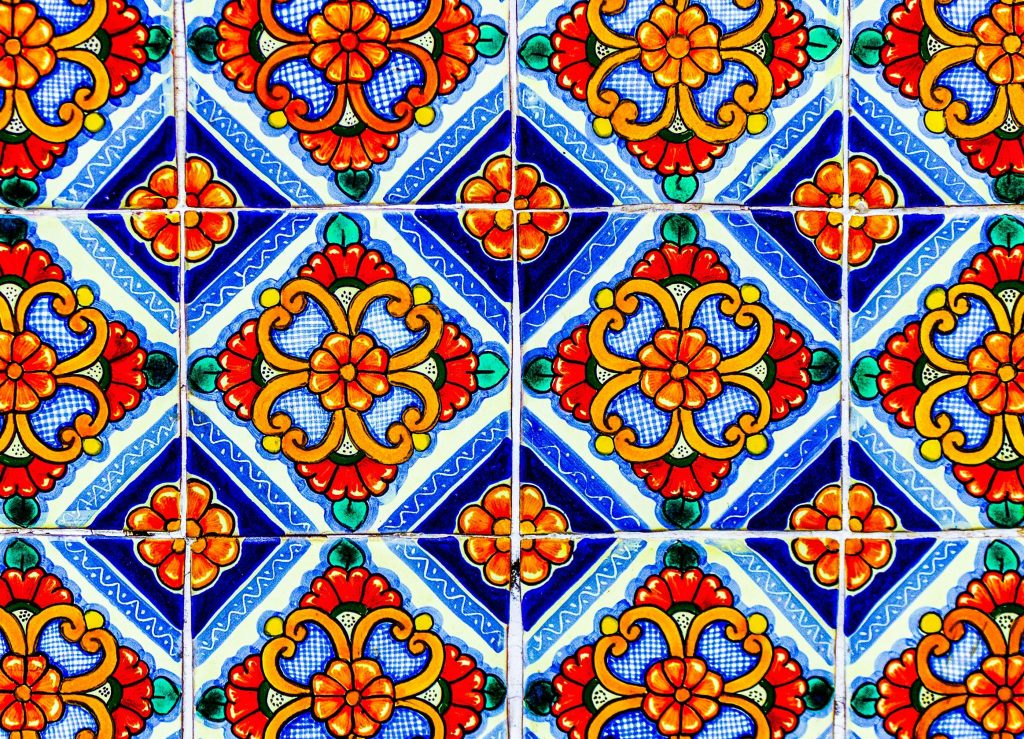 Colorful Mexican Talavera tiles with intricate patterns and vibrant floral designs.