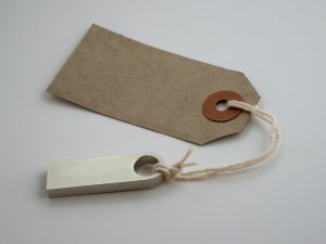 A minimalist paper tag with twine string on a neutral background, ideal for product labeling.